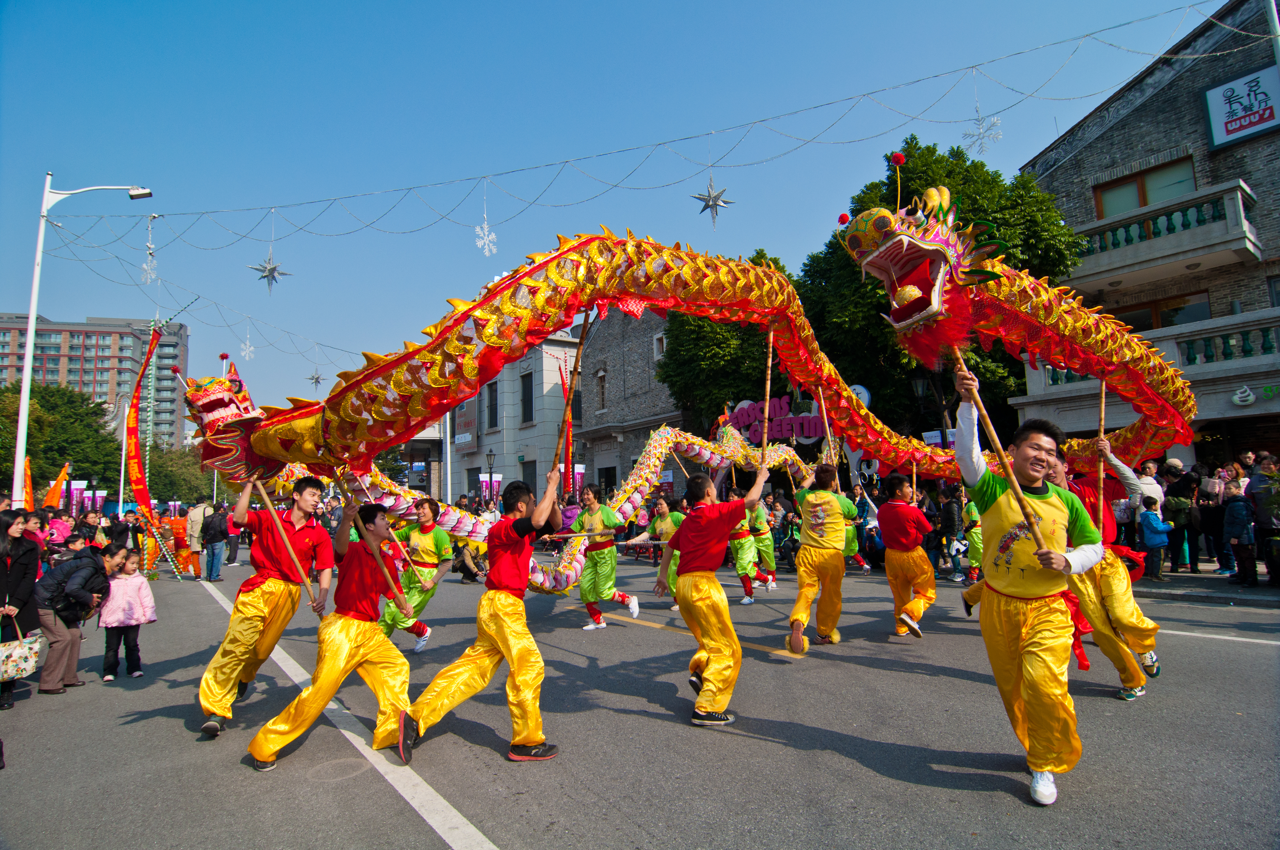 Mensen aan het dansen in de straten met een Chinese draak in hun handen
